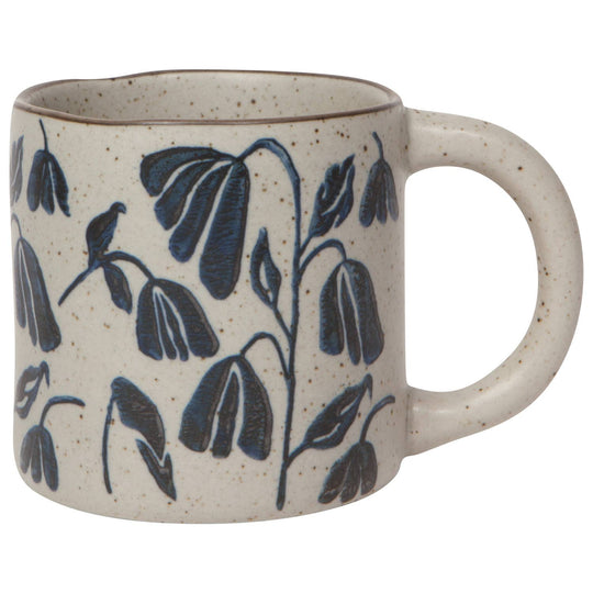 Ceramic mug with blue leaf patterns on a white background