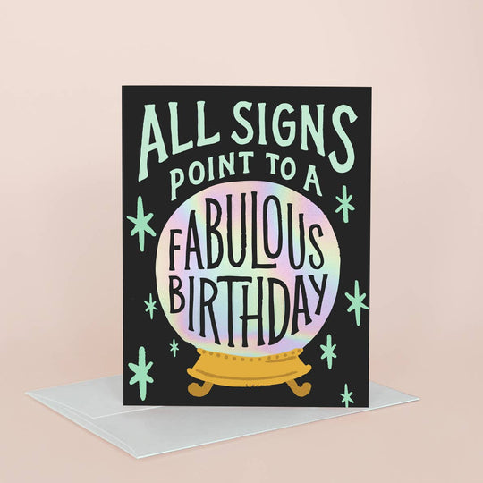 Greeting card with 'All signs point to a fabulous birthday' text on a black background