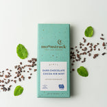 moOnstruck dark chocolate cocoa nib mint bar with mint leaves on a white background