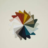 Colorful fabric napkins arranged in a circular pattern for table settings
