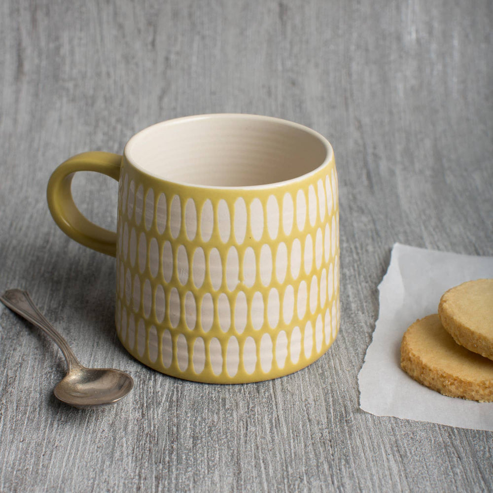 Yellow and white stoneware coffee mug