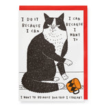 A square greeting card with a red border and a black-and-white illustrated cat sitting on a white background, surrounded by hand-lettered text. A small orange-and-black patterned object appears near the cat's feet.
