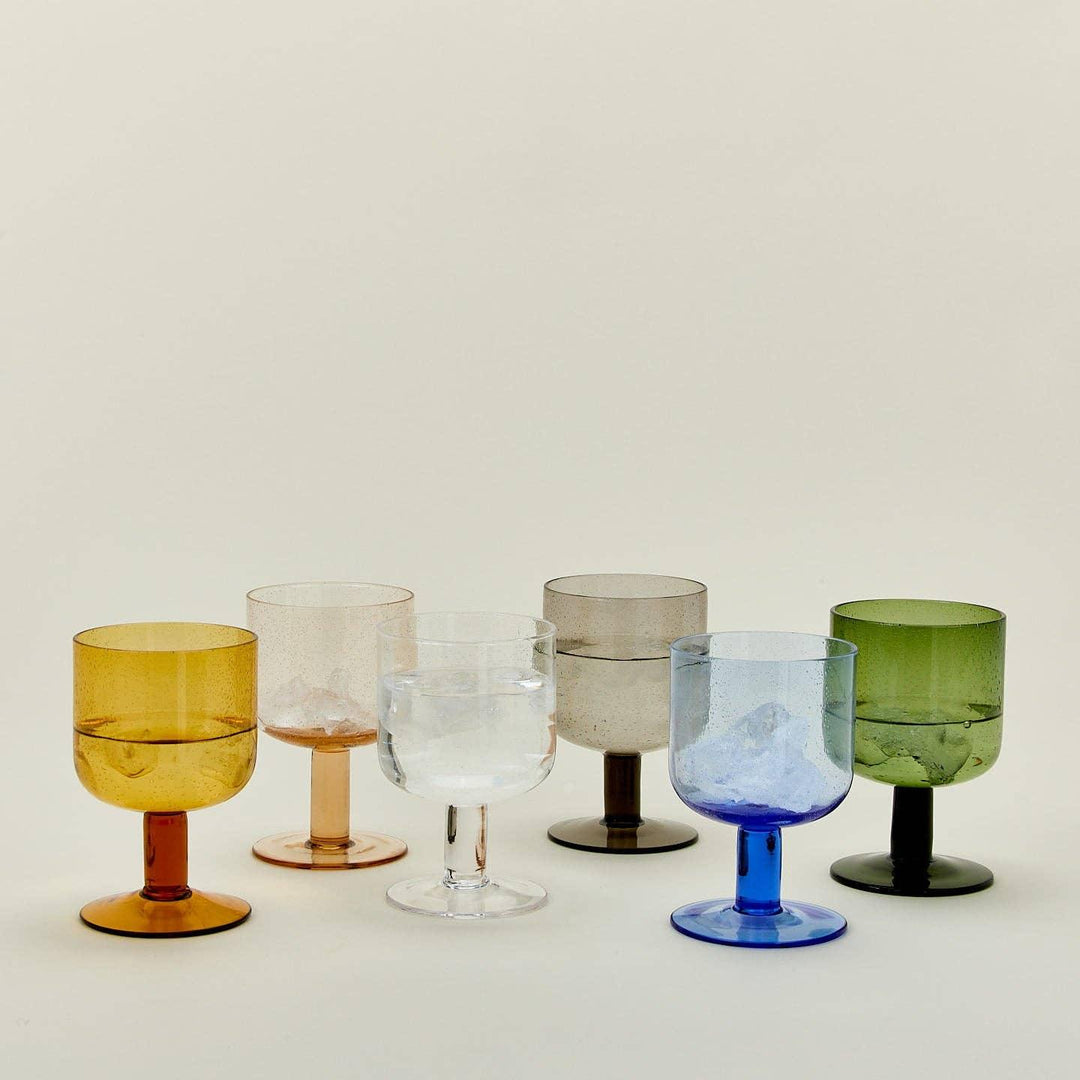 Colorful glass goblets with ice, perfect for floral-themed gatherings and curated gifts