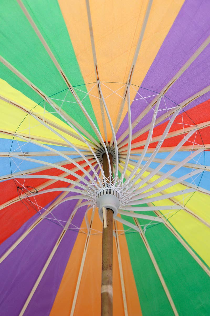Close-up of a colorful umbrella with a rainbow pattern.