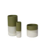 Three cylindrical vases with green and white design on a white background