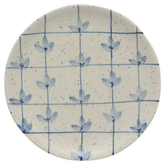 Round ceramic plate with blue floral pattern on a white background