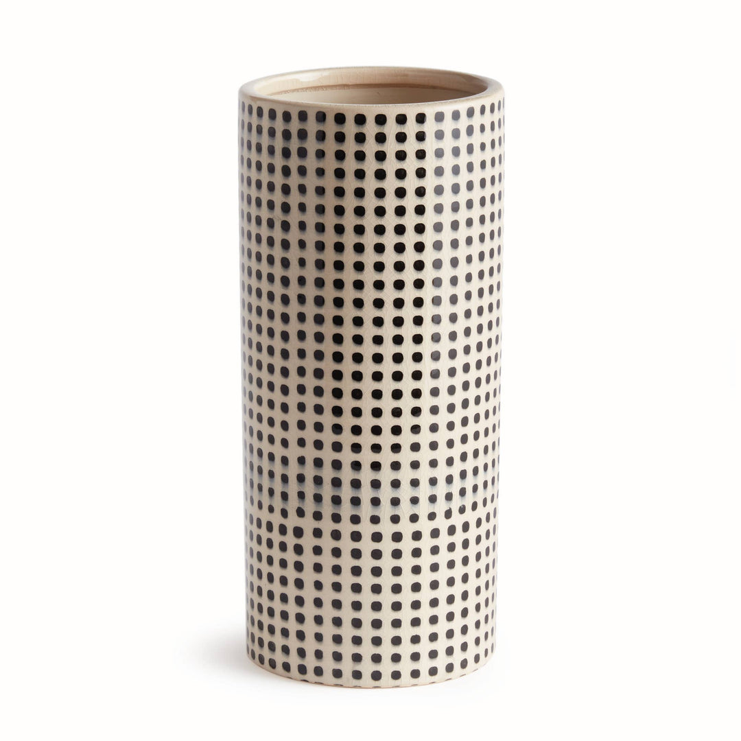 Cylindrical ceramic vase with black dot pattern on a white background