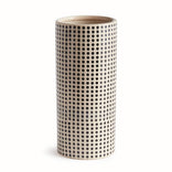 Cylindrical ceramic vase with black dot pattern on a white background