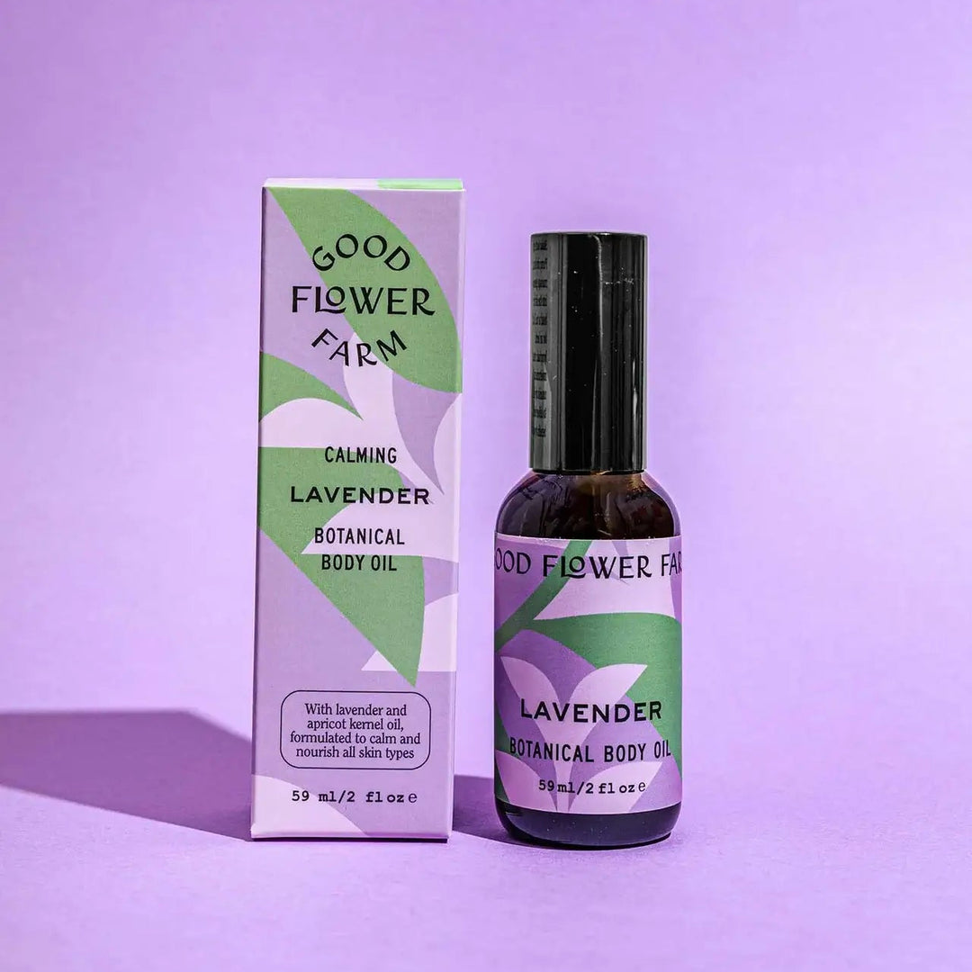 Good Flower Farm lavender botanical body oil bottle and packaging on a purple background