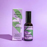 Good Flower Farm lavender botanical body oil bottle and packaging on a purple background