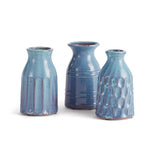 Three blue ceramic vases of different shapes on a white background