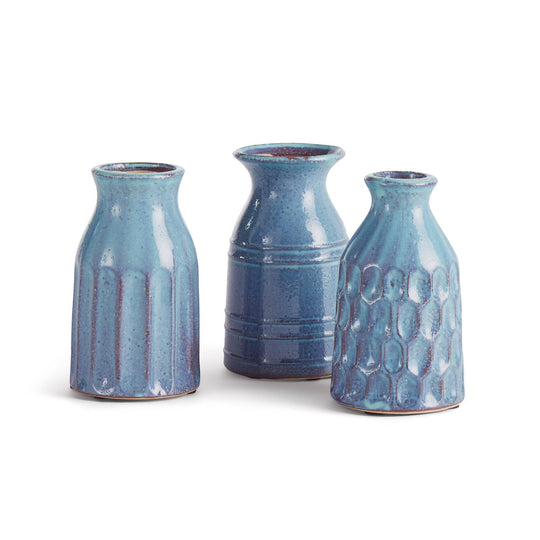 Three blue ceramic vases of different shapes on a white background