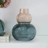 Elegant blue and pink glass vase with floral arrangement, perfect for home decor or gifting.