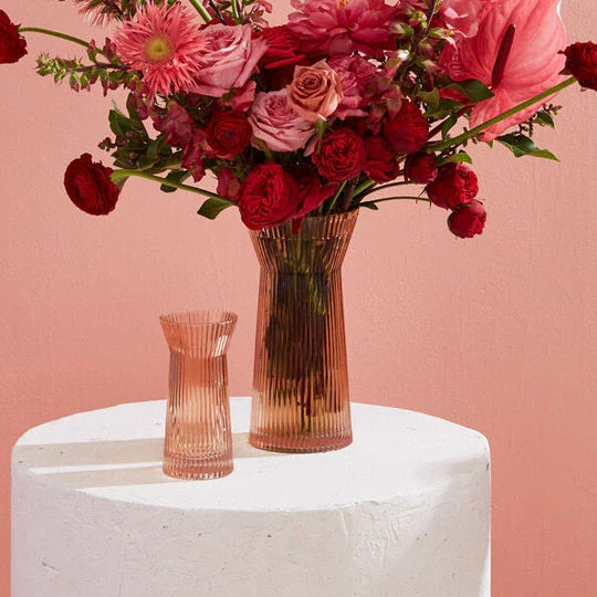 Vibrant red and pink floral arrangement in a ribbed vase, perfect for Washington DC flower delivery.